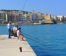 fishermen on the city promenade in malta