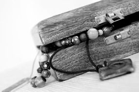 black and white photo of a wooden casket with bracelets