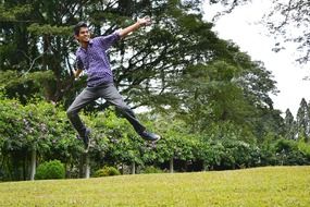 Happy jumping man among nature in Sri Lanka