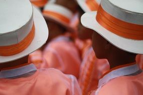 people in white and orange hats on celebration