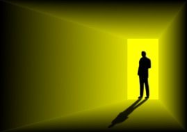 black silhouette of a man in a bright doorway