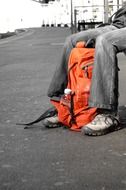 orange rucksack at feet