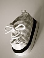 black and white photo of shoes of a newborn baby