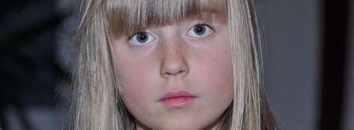 portrait of a little girl with blond hair and big eyes