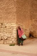 old woman in a pink scarf in Morocco