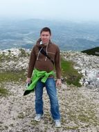 young man in jeans on mountain summit, austria, salzburg