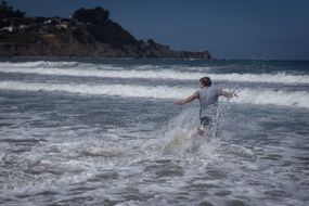 Child running to waves