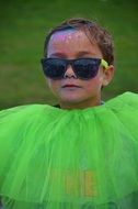little girl in green dress and sunglasses