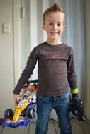 boy with race cars toys