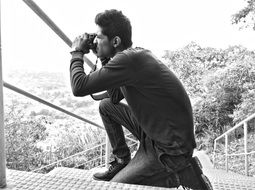 black and white photo of a photographer on the stairs