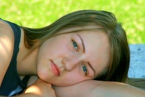 portrait of lying girl with blond hair