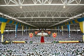 a crowd of meditating Buddhist people in Thailand