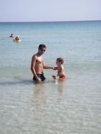 father and son in ocean