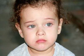 curly-haired toddler with innocent facial expression