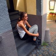 teen girl on the stairs at the entrance to the house