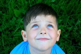 child boy with blue eyes looking up