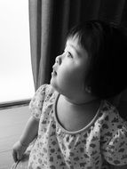 asian child girl looking up, greyscale portrait