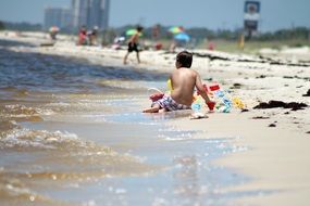 boy playing by beach