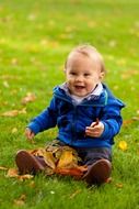 Baby on the grass in autumn