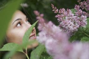 Photoshoot of the girl and lilac flowers