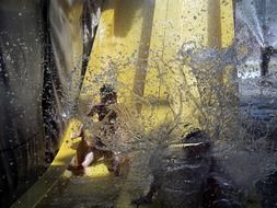 children on a water slide in a spray of water