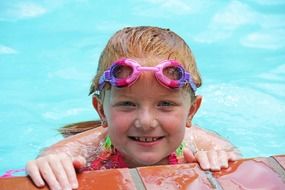 girl in swimming glasses in the pool