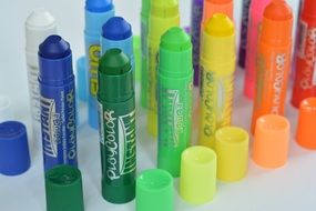 pencils of different colors on a white surface