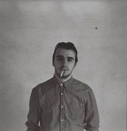 black and white portrait of a man with a cigarette