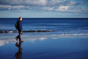 adult man walk on the beach