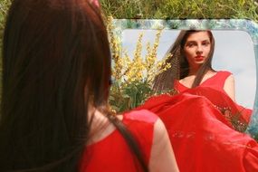 reflection in a mirror of a nice girl with red lipstick