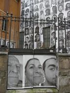 black and white portraits of people on old wall