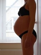 pregnant woman in black underwear