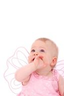 Little girl in pink dress looks up