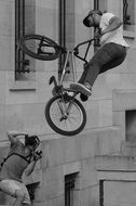 Black and white image of a trick on a bicycle