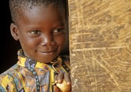smiling black child near the door