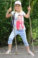 smiling caucasian child girl holding on rope