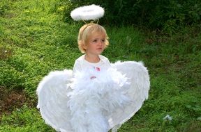 child in angel costume on the street