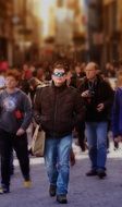 Photo of walking man in the crowd