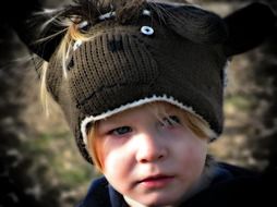 child in thematic hat