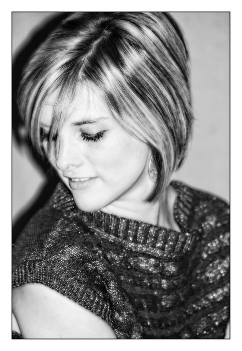 beautiful girl in a half turn in black white background