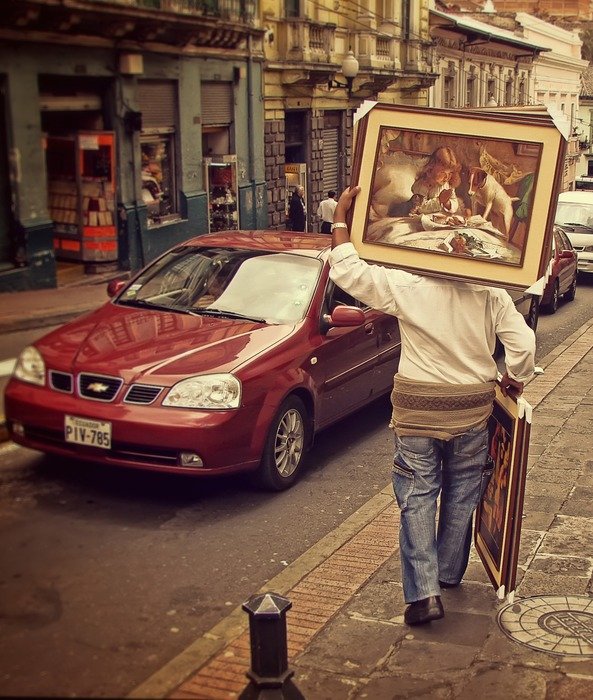 man with pictures on the street