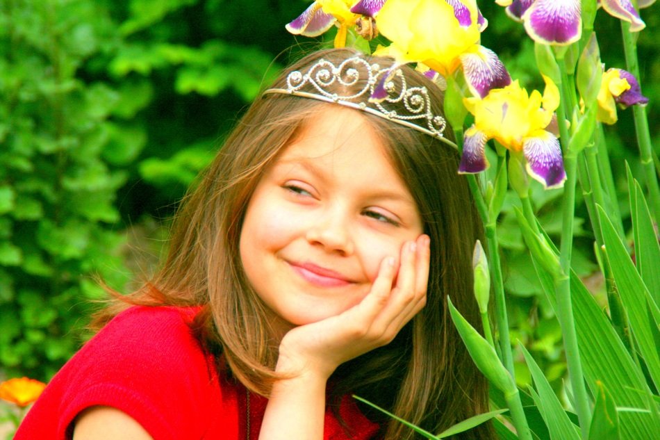 portrait of a smiling child on the background of flowers