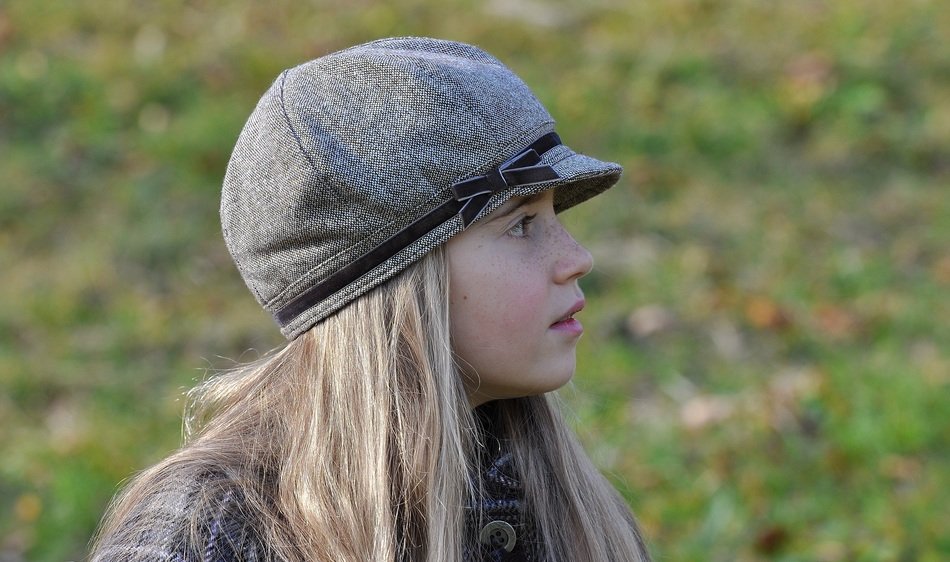 blond girl in the cap side view