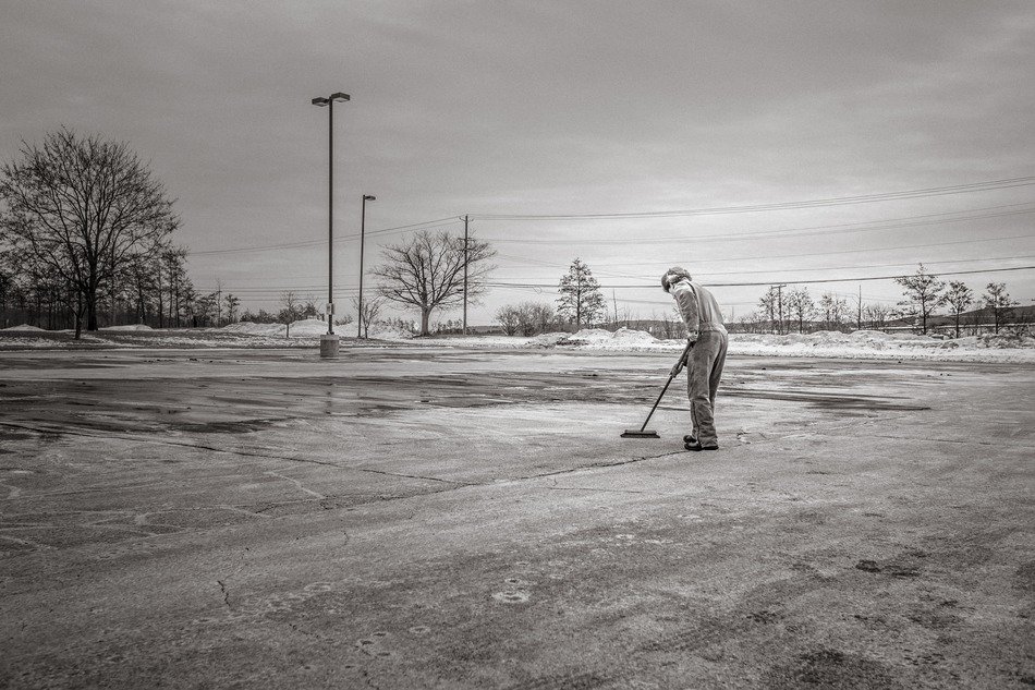 Black and white photo of the clearing the main street of garbage