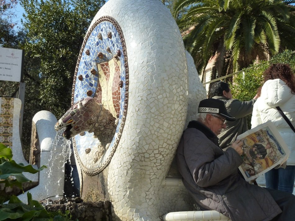 Photo of a man with a newspaper in Park Guell, Barcelona