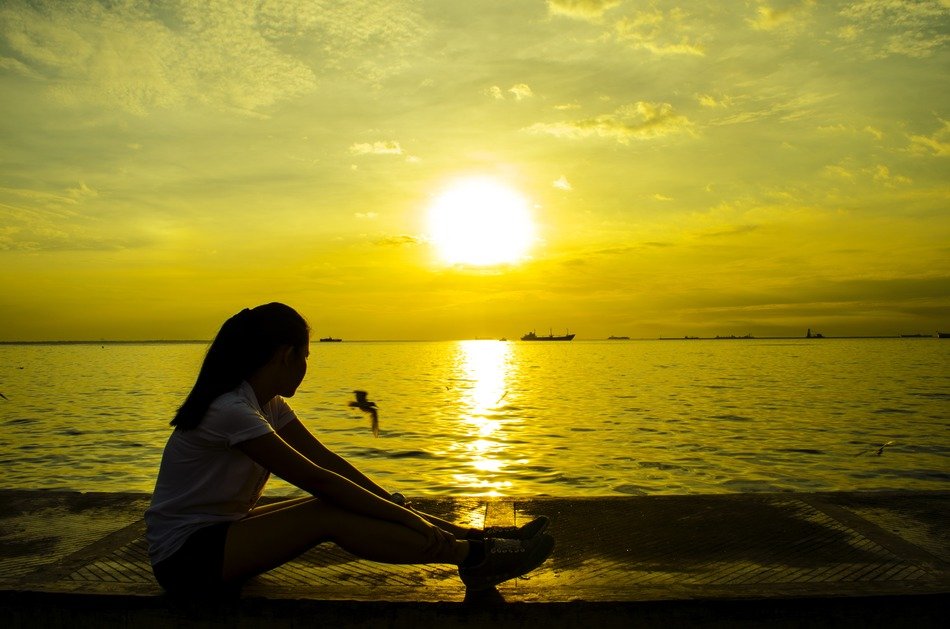 girl is resting on the background of the sunrise
