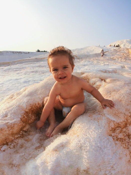 baby splashing on the beach