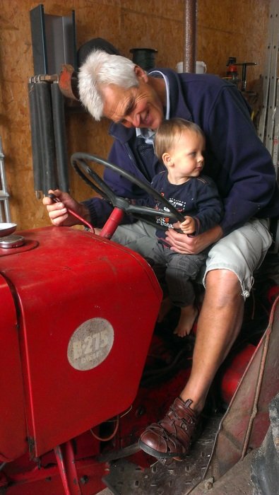 grandfather and child on the tractor