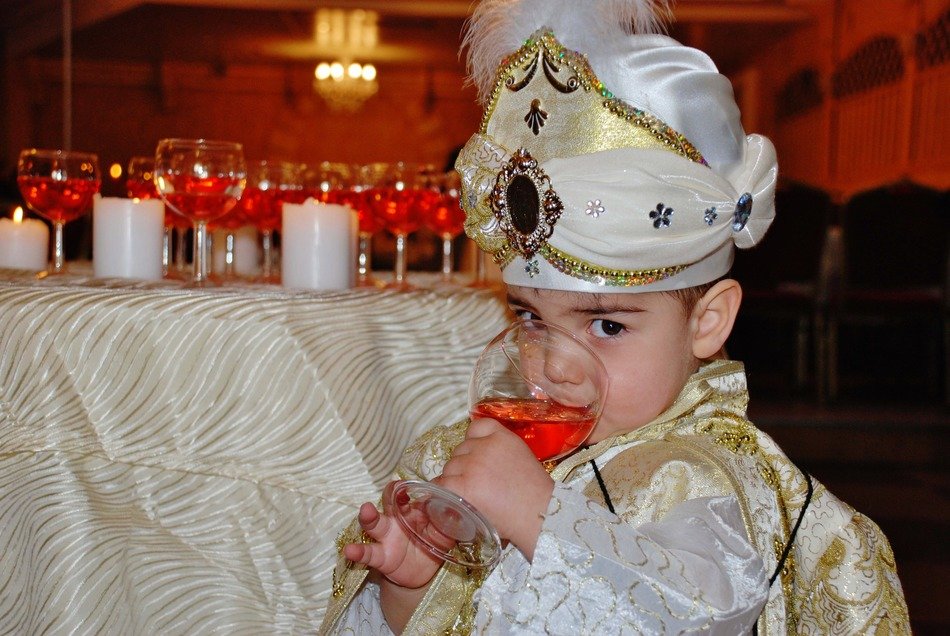 cute kid drink from a glass