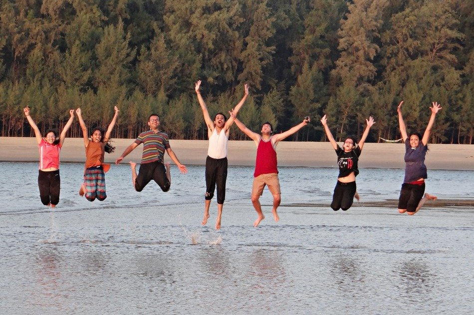 young people on the shores of the arabian sea